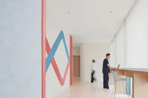 Minimalist design with white walls and red and blue patterns in a hospitality interior setting
