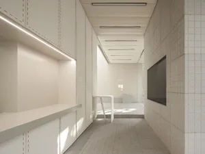 A minimalist office interior with concrete flooring and glass walls.