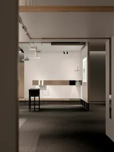 An image of a minimalist exhibition space with white walls and modern art displays.