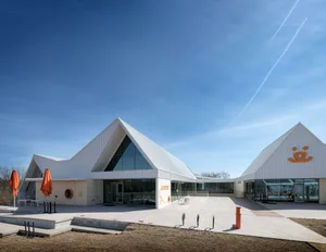 A modern building with a glass exterior on a clear day.
