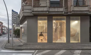 A modern commercial interior featuring large glass panels and a minimalist design.