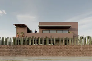 A modern house with concrete and glass exterior materials.