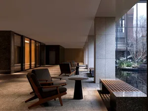 Modern minimalist lobby featuring concrete and glass materials.