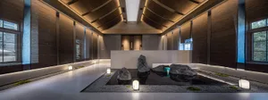 A minimalist spa interior featuring concrete and glass elements.