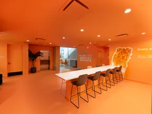 Interior design of a modern lobby with vibrant orange elements.
