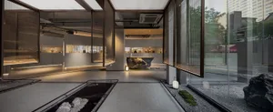 A minimalist museum exhibit space featuring concrete walls and glass elements.
