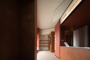 Modern office reception area with industrial design elements and wood materials