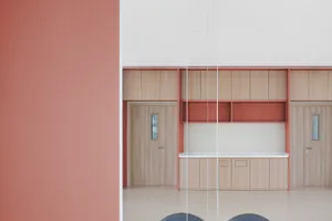 Modern office space featuring wooden furniture and cabinets.