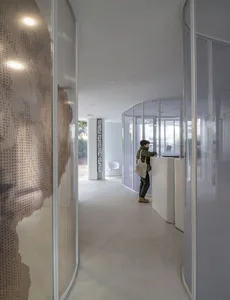 A modern reception area with a glass curtain and a white reception desk.