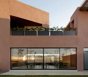 Modern restaurant interior with concrete walls and glass panels