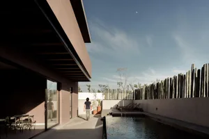 Modern residential house featuring concrete exterior, sustainable design elements, and a minimalist aesthetic.
