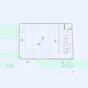 Floor plan of an office space, showing desks, chairs, and a staircase.