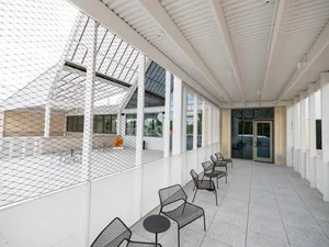 Modern, minimalist design featuring industrial metal wire furniture and white steel elements.