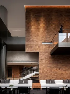 Modern architectural space featuring a wooden panel wall and contemporary furniture.