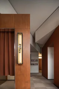 Interior of a photography studio with wooden panels and lighting equipment.