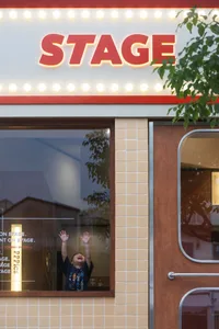 A storefront with tiles and a concrete facade.