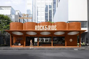 Modern restaurant exterior with corten steel and concrete features.