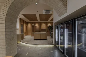Industrial-style commercial kitchen featuring concrete flooring and wooden cabinets.