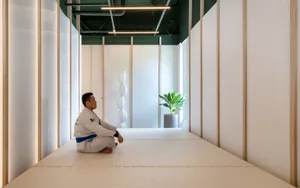 A minimalist exercise room with a white interior, serene atmosphere, and a focus on functionality.
