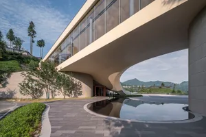 A modern architectural commercial office building featuring glass and concrete materials.