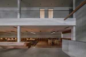 A modern conference room with concrete floors and industrial design features.