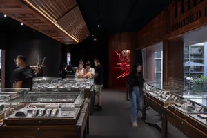 A minimalist jewelry store with glass counters, showcasing a variety of jewelry.