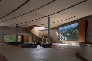 Contemporary lobby with concrete walls and spiral staircase