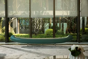 Modern lobby featuring a glass window with a futuristic, contemporary interior design and seating furniture.
