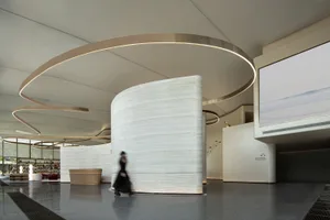A contemporary lobby featuring minimalist design with marble walls and flooring.