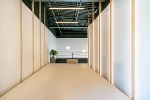 A modern minimalist living room with white paper flooring.