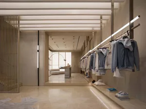 A modern retail interior featuring neatly hung clothing items in a contemporary setting.