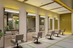 Modern, spacious salon interior with sleek, contemporary styling, illuminated by soft, ambient lighting.