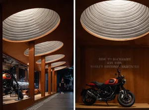 A motorcycle exhibit featuring metallic and wooden structures.