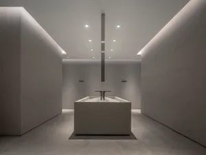 Modern minimalist bathroom featuring a concrete sink and floor.
