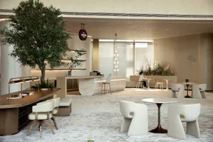 A modern cafe lounge with minimalist interior design featuring neutral materials and a variety of seating arrangements.