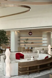 A modern commercial space featuring contemporary furniture and lighting, with a focus on minimalist design principles.