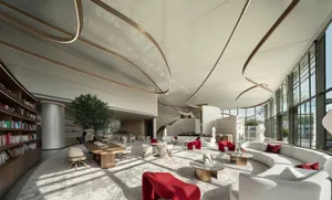 Modern hotel lobby with white furniture and glass walls