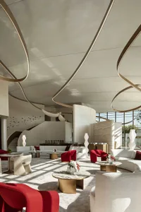 Modern lobby featuring sleek concrete, marble, and glass materials.