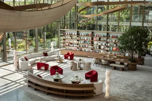 A modern lounge space featuring marble, wood, and fabric materials.