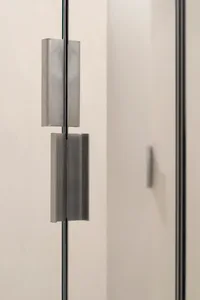 Modern, metal door handle on a white wall