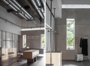 Interior of a minimalist retail store with concrete walls and minimalistic design elements.