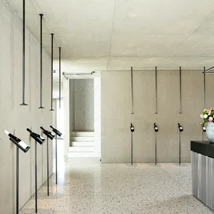 Modern interior design featuring a minimalist space with concrete walls and floors.