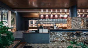 Modern restaurant interior with stone, wood, and metal materials.
