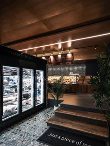 A modern retail space featuring a combination of wood, glass, and tile materials.
