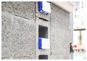 Concrete blocks with blue and white objects attached to them