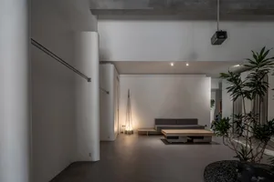 Minimalist interior design featuring concrete materials in a living space.