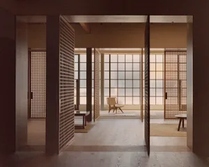 A minimalist residential interior featuring a cozy living space with wood paneling and a large glass window.