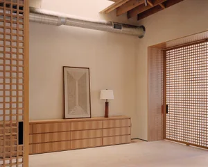 A modern-industrial living space featuring wooden furniture and decor.
