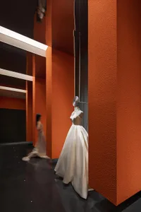 Mannequin wearing a modern, elegant dress in a retail setting.