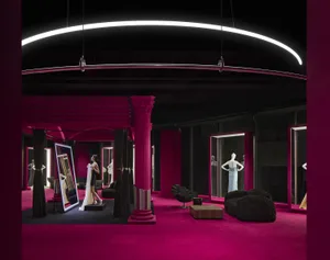 Modern showroom with purple curtains and a pink carpet.